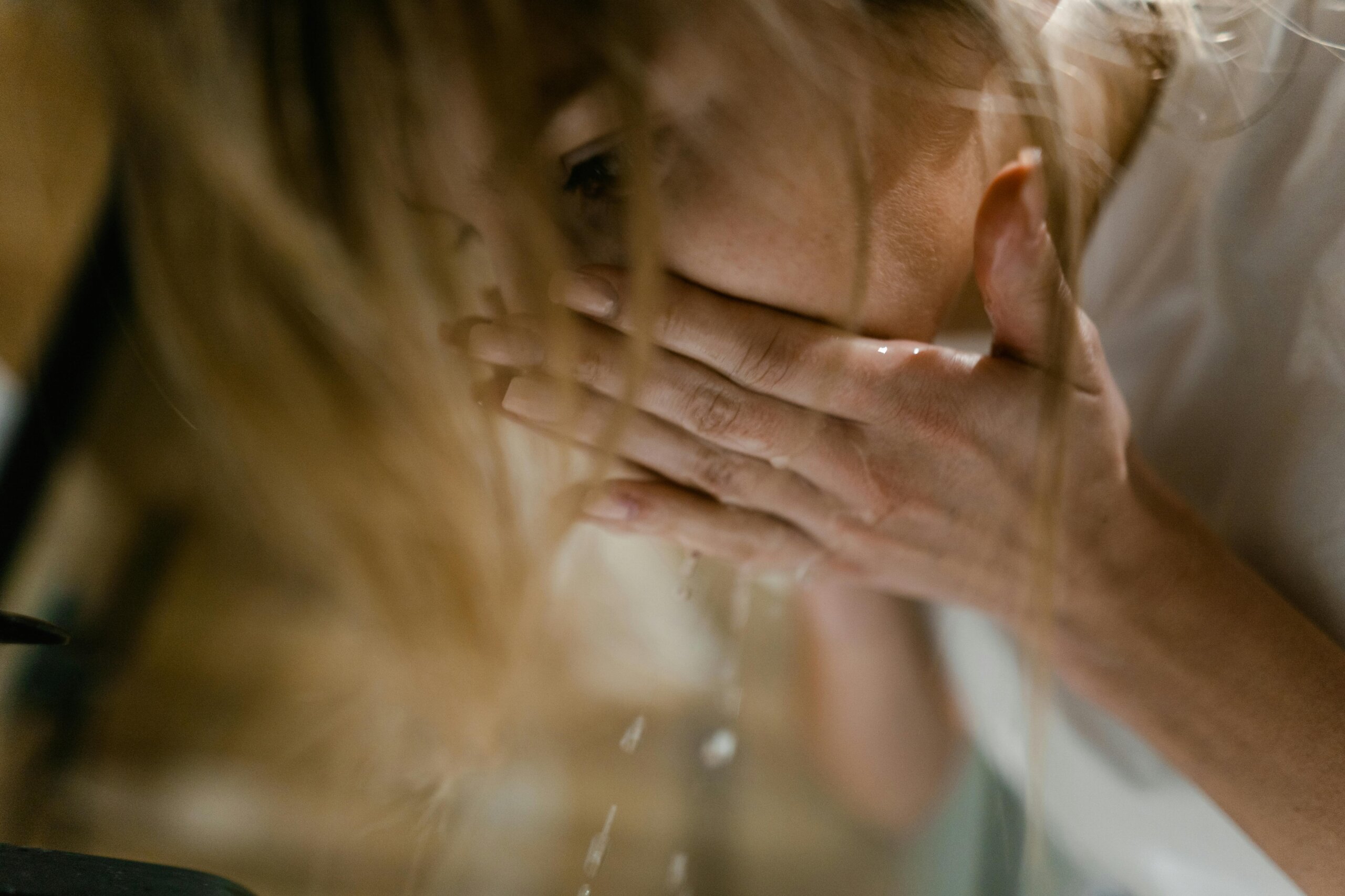 a woman washing her face